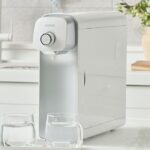 PUREAL water purifier on a kitchen counter with two glasses of filtered water