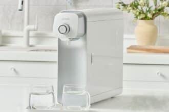 PUREAL water purifier on a kitchen counter with two glasses of filtered water